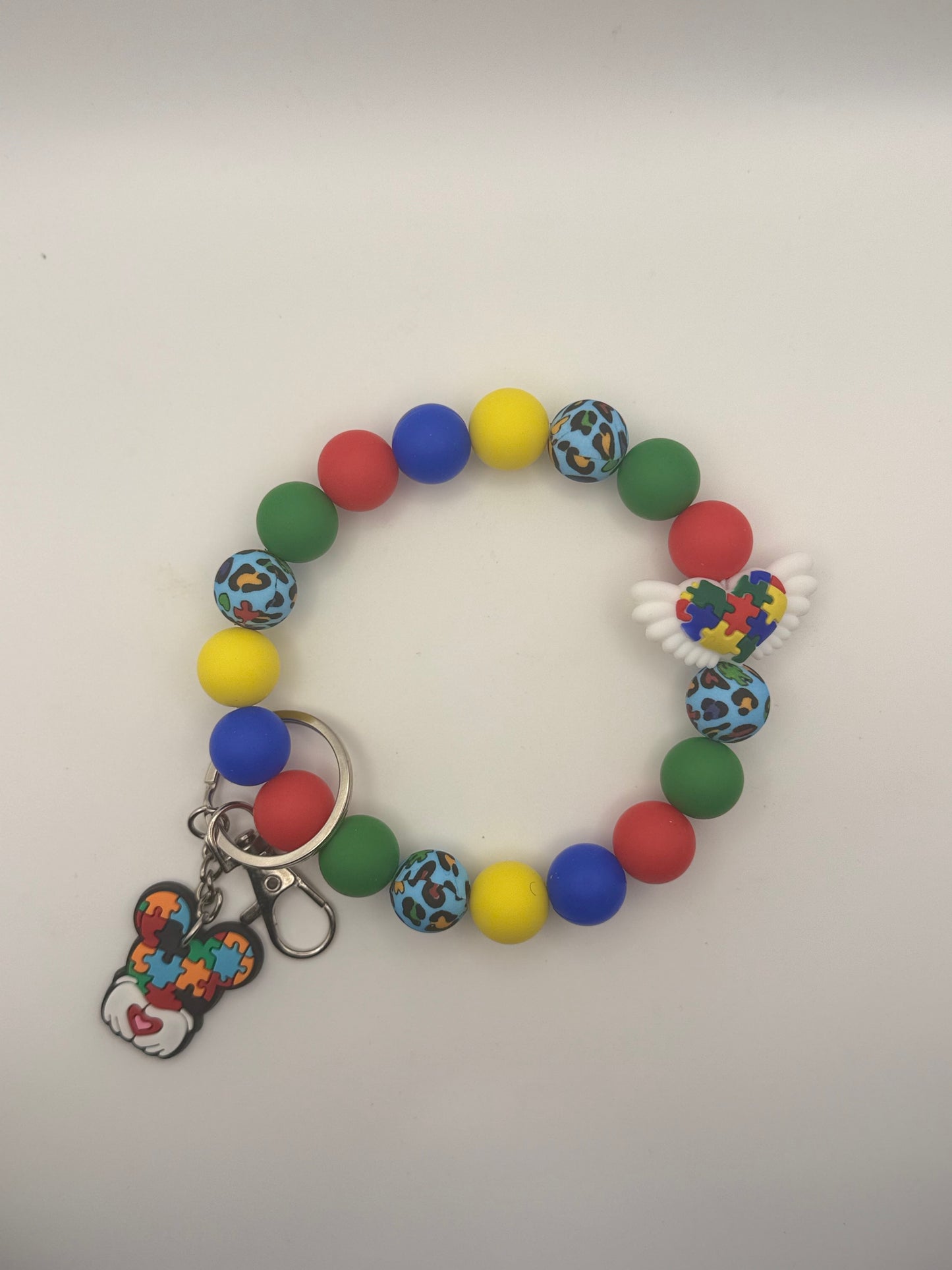 Colorful beaded bracelet with keychain on a white background