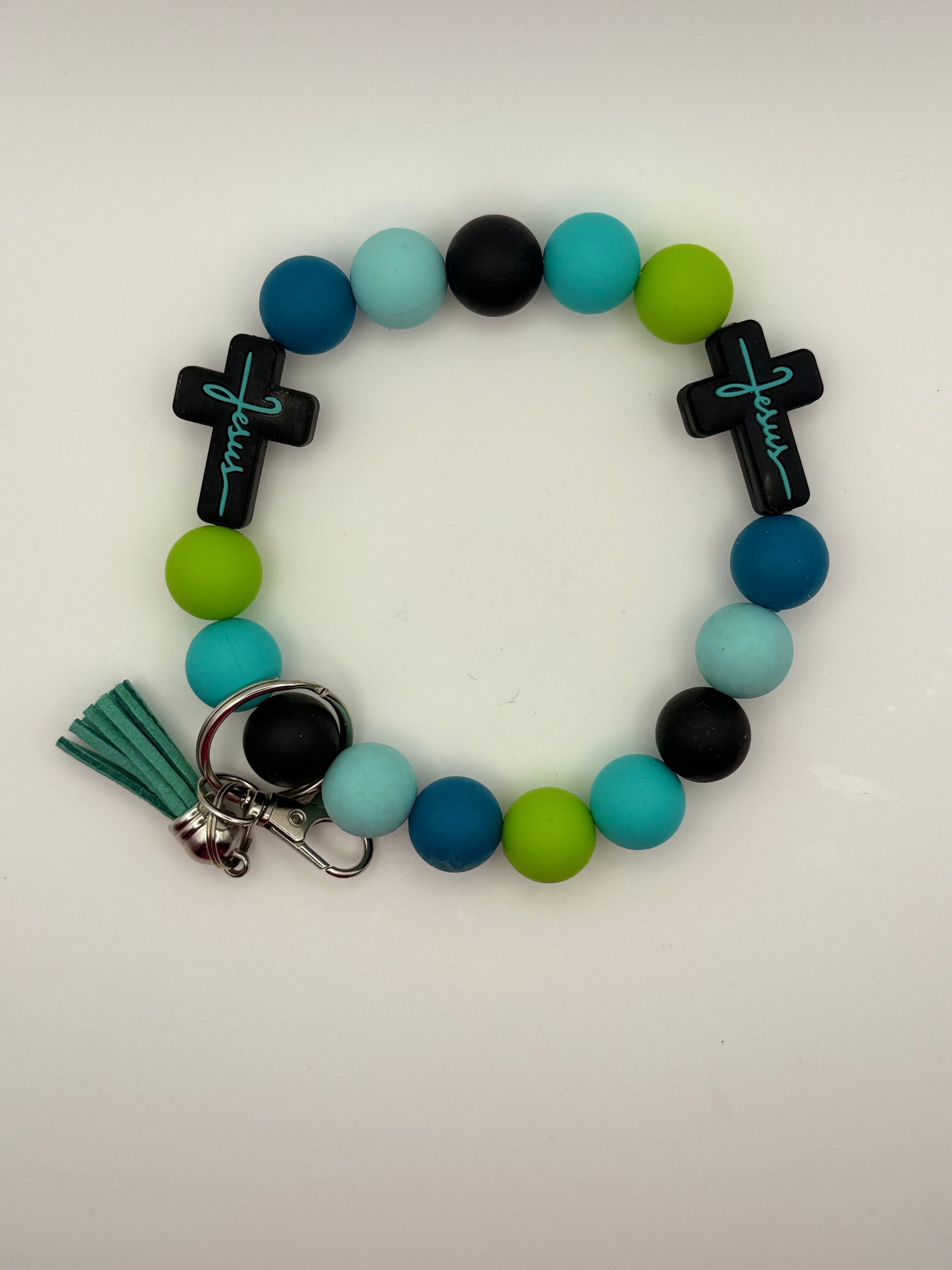 Colorful beaded bracelet with crosses and a tassel on a white background