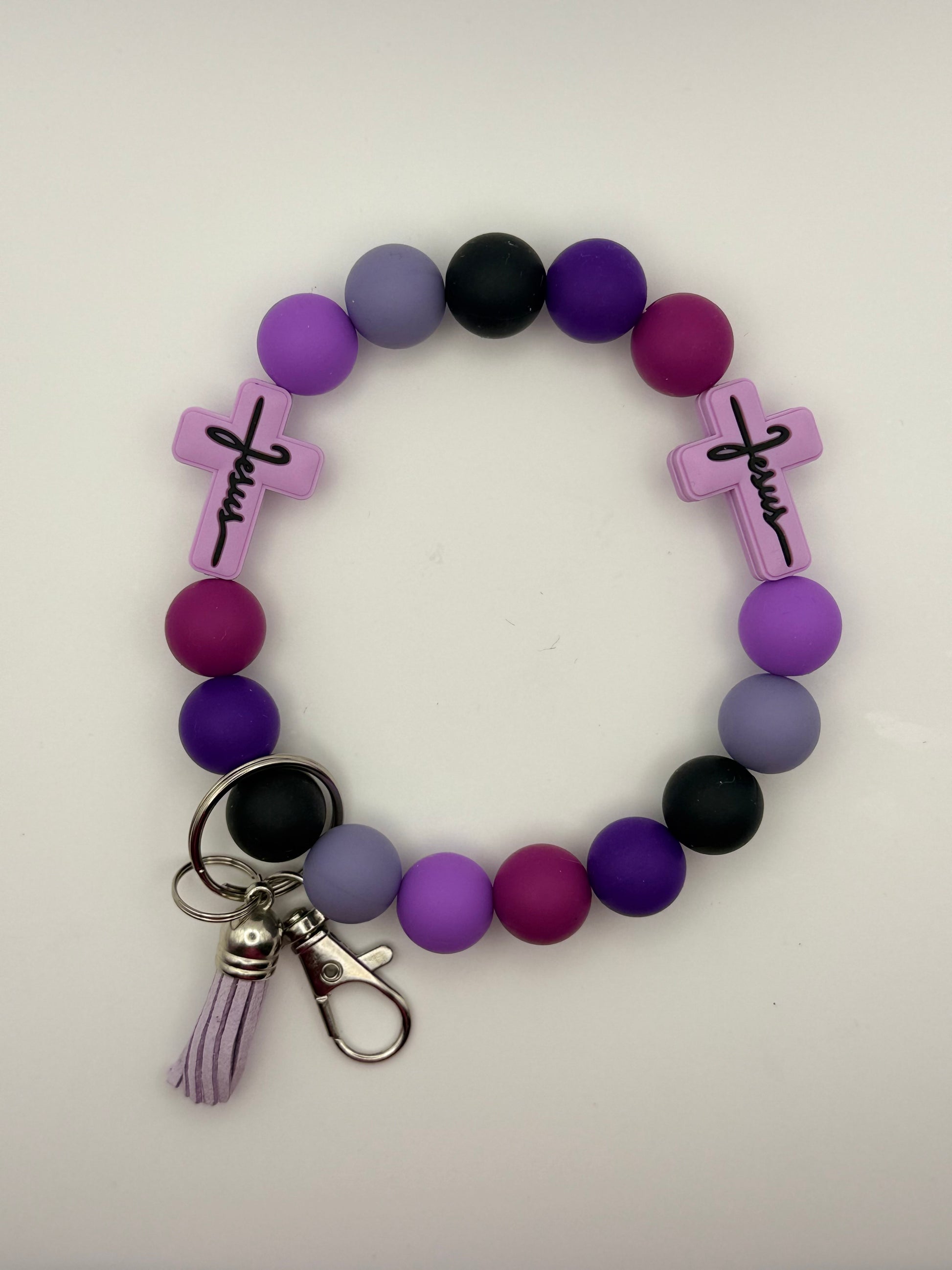 Beaded bracelet with crosses and a keychain on a white background
