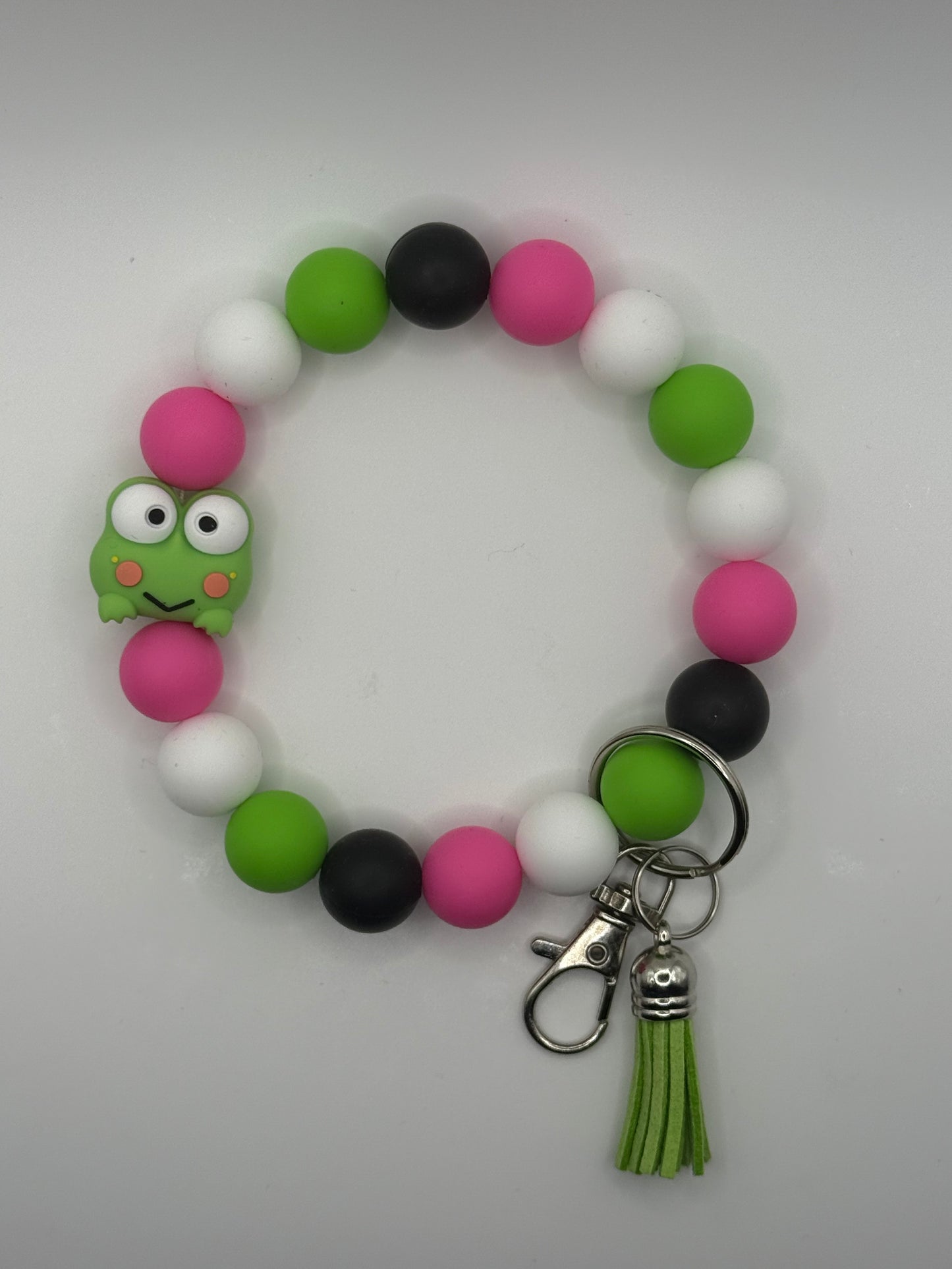 Colorful keychain with a frog charm on a white background