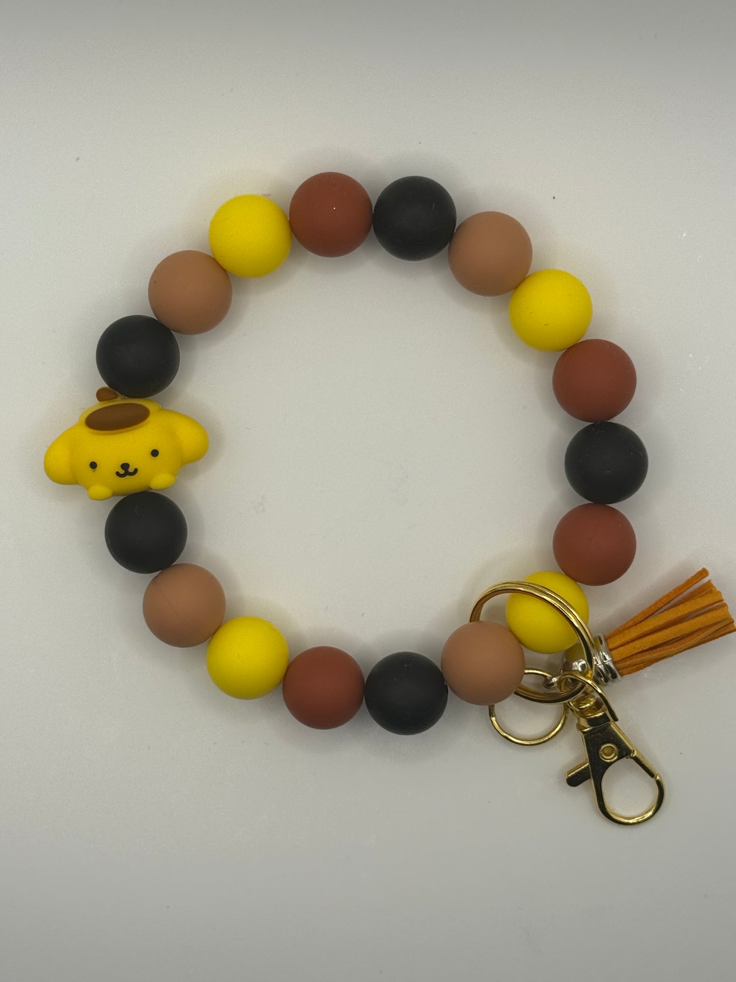 Bracelet with colorful beads and a golden retriever charm on a white background