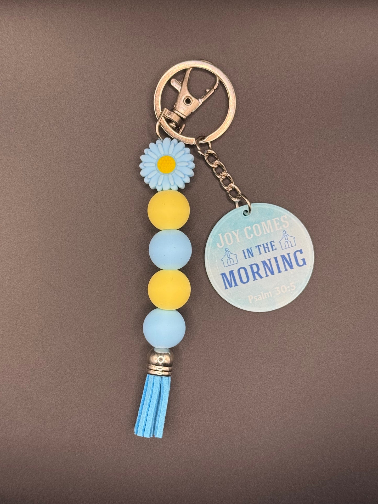 Blue Flower Keychain with decorative elements on a gray background