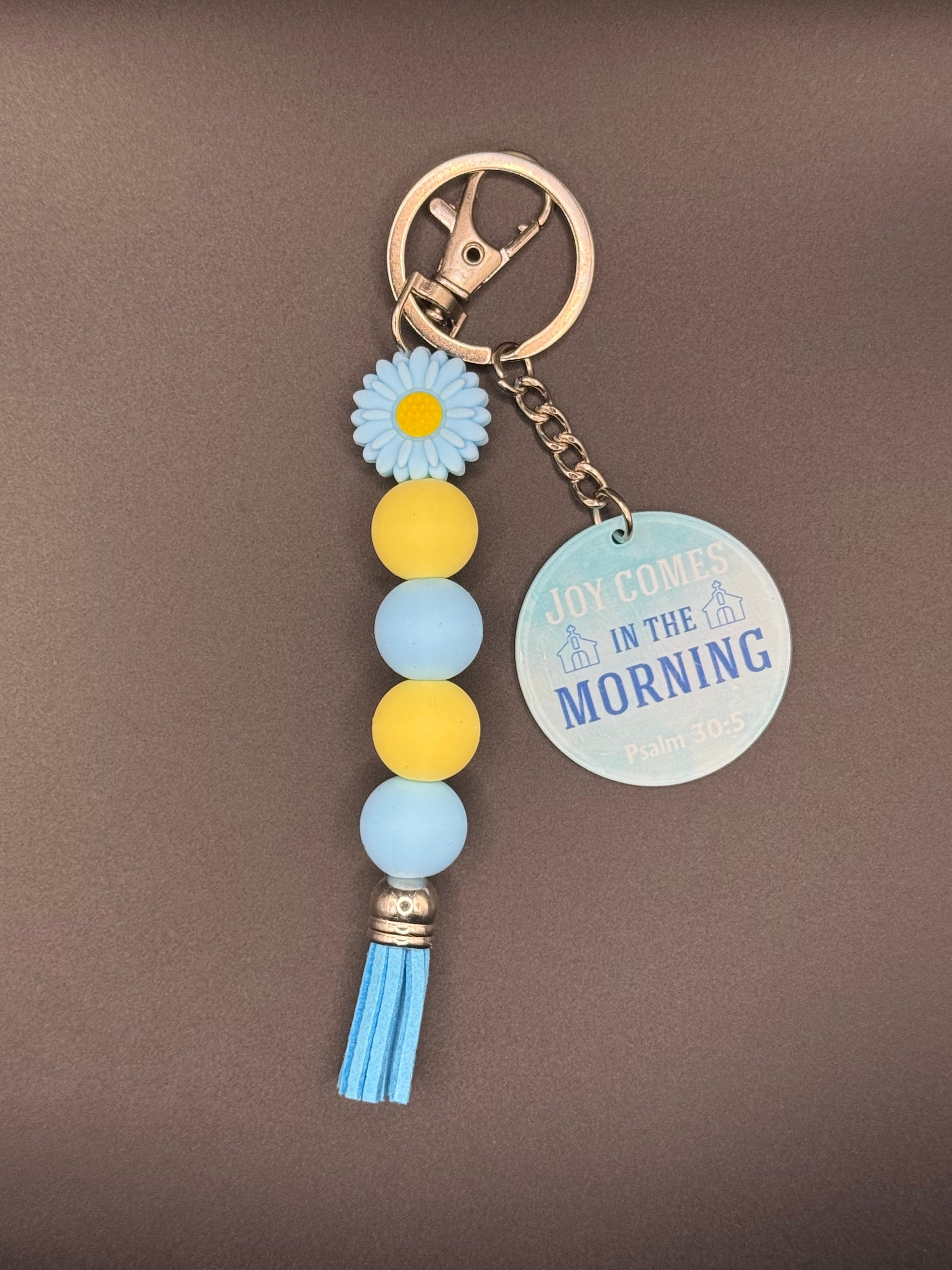 Blue Flower Keychain with decorative elements on a gray background