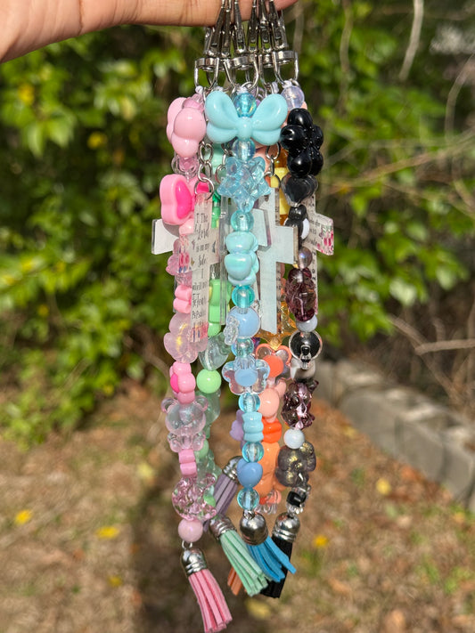 Colorful Acrylic beads held against a natural background