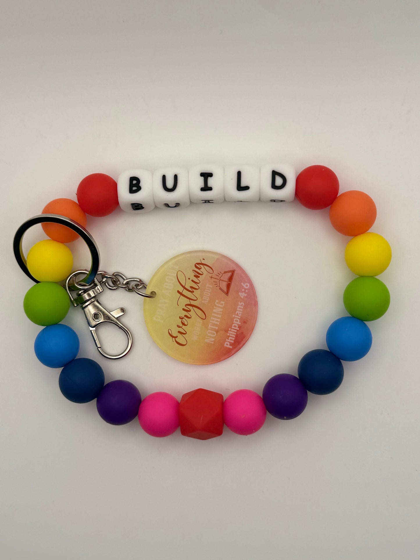 Colorful beaded keychain with letter beads spelling 'BUILD' on a white background