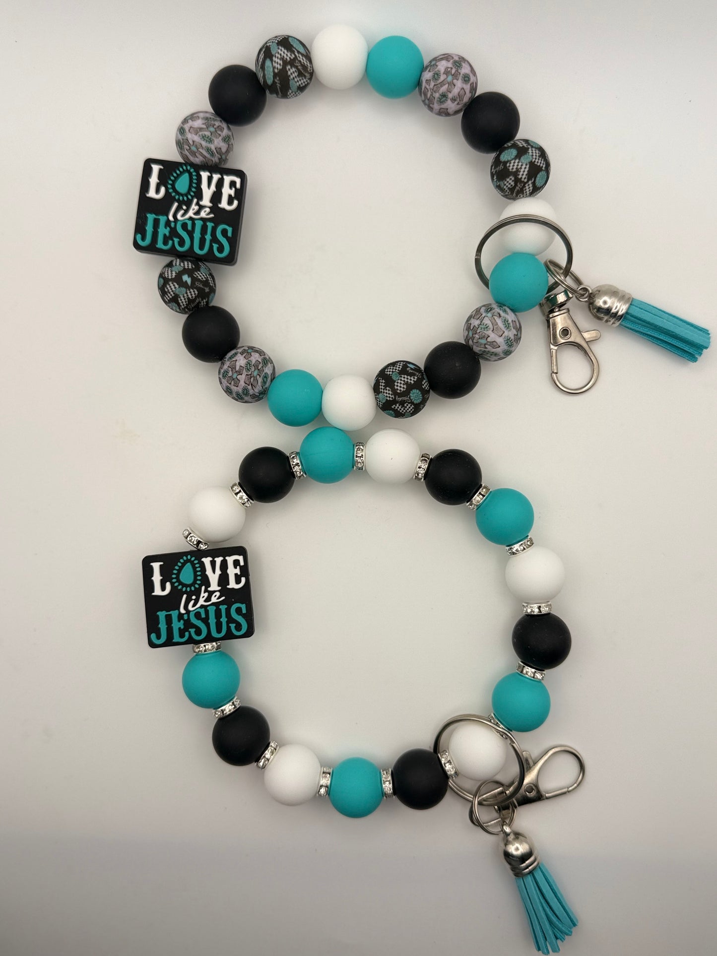 Beaded keychain with 'Love like Jesus' charms on a white background