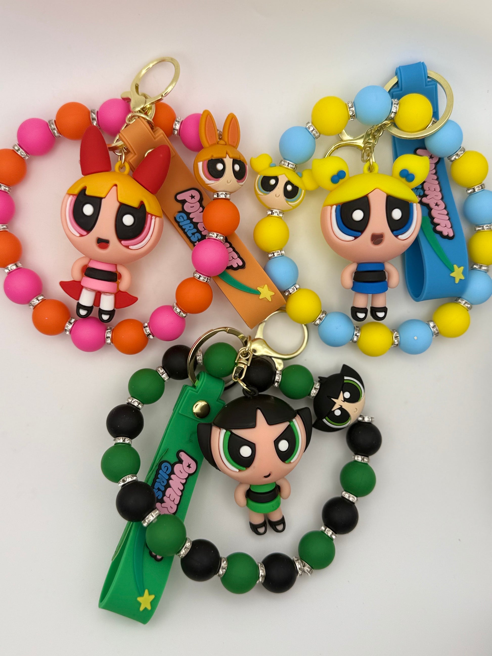 Colorful keychains with cartoon character figures on a white background