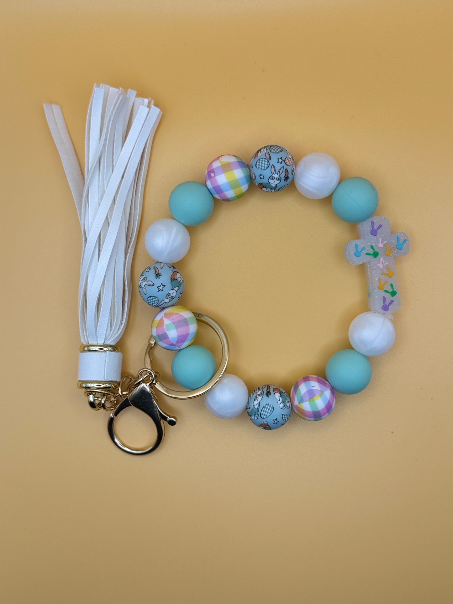 Beaded keychain with tassel on a beige background