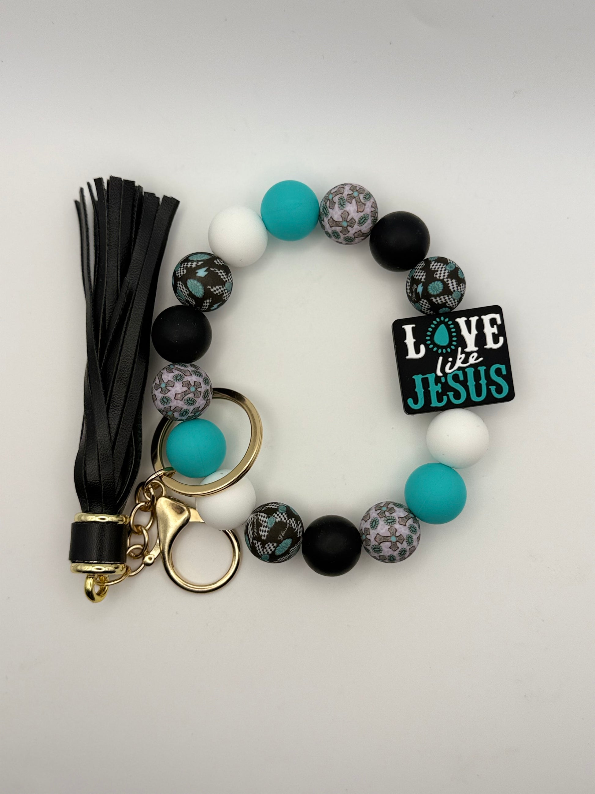 Bracelet with beads, tassel, and keychain on a white background