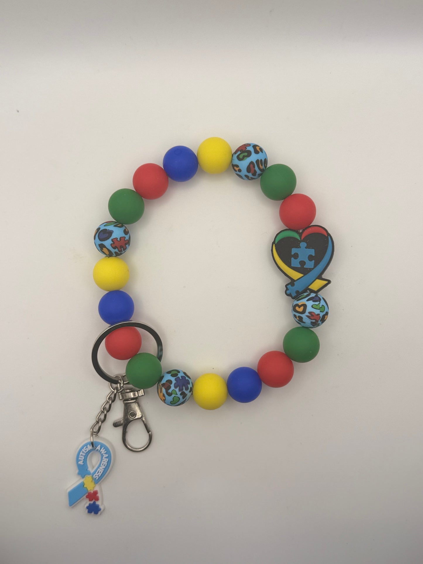 Colorful beaded keychain with a heart-shaped charm on a white background