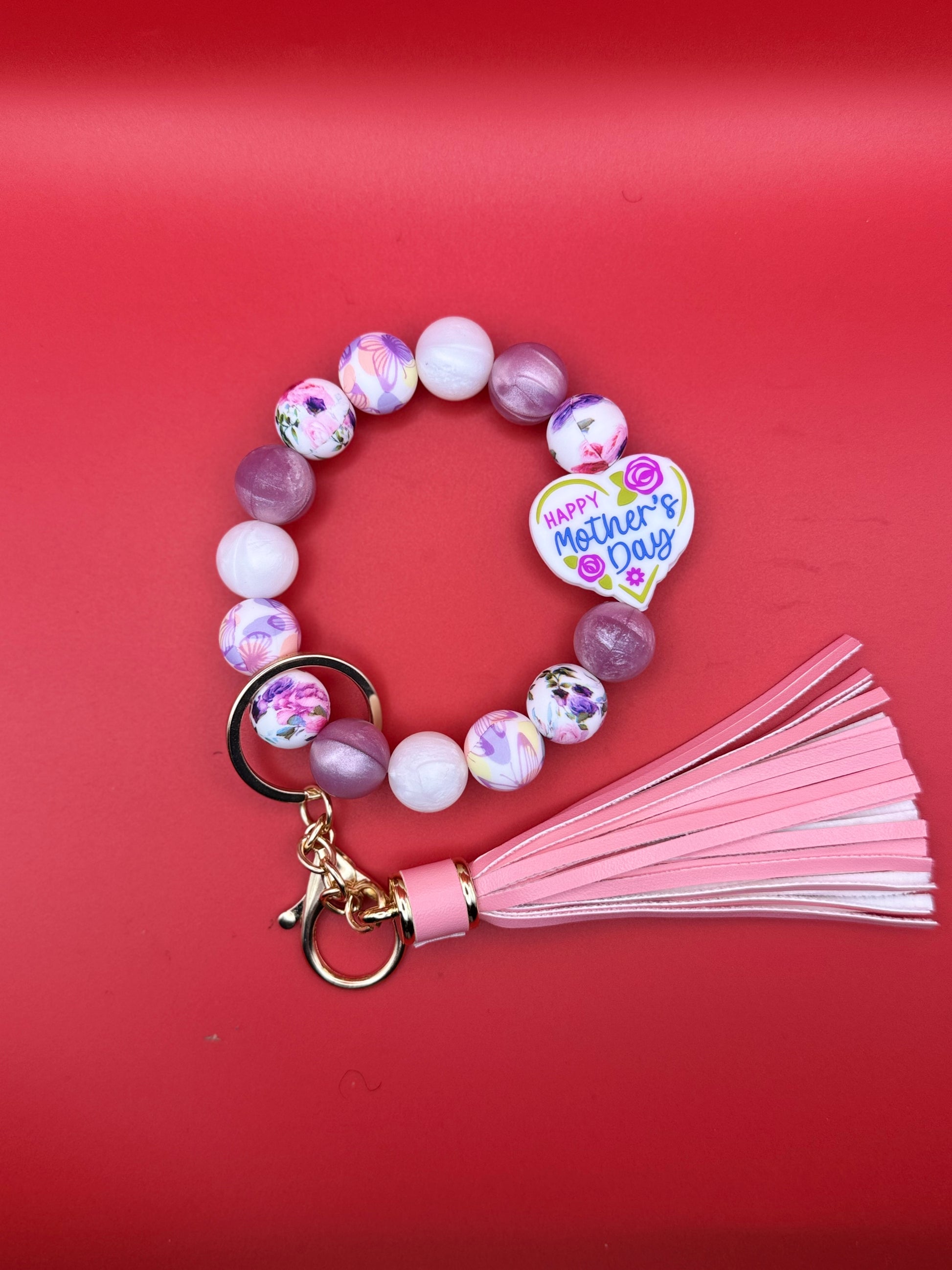 Beaded keychain with pink tassel and 'Happy Mother's Day' heart charm on a red background